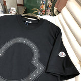 Side profile of Moncler luxury clothing with monogram-inspired silhouette