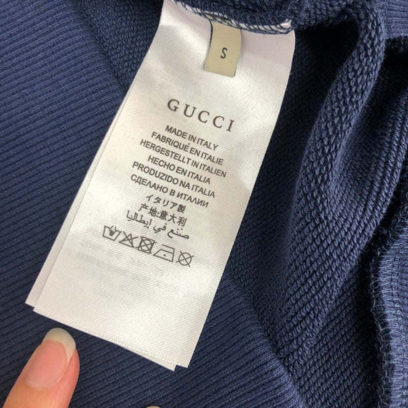 Side profile of Gucci luxury clothing with relaxed-fit cut
