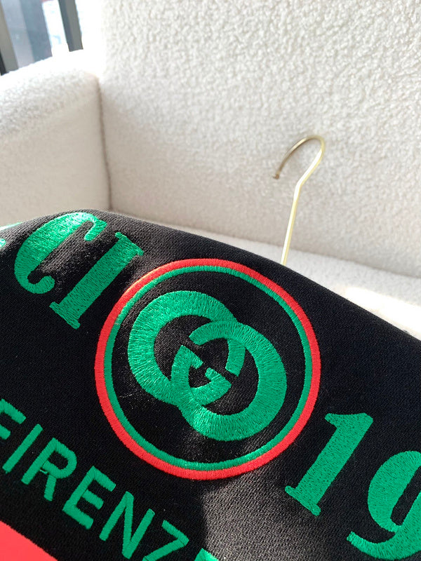 Close-up detail shot of Gucci luxury clothing with monogram-inspired silhouette