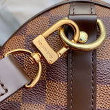 Styled lifestyle shot of polished signature women's handbag – women's luxury handbag