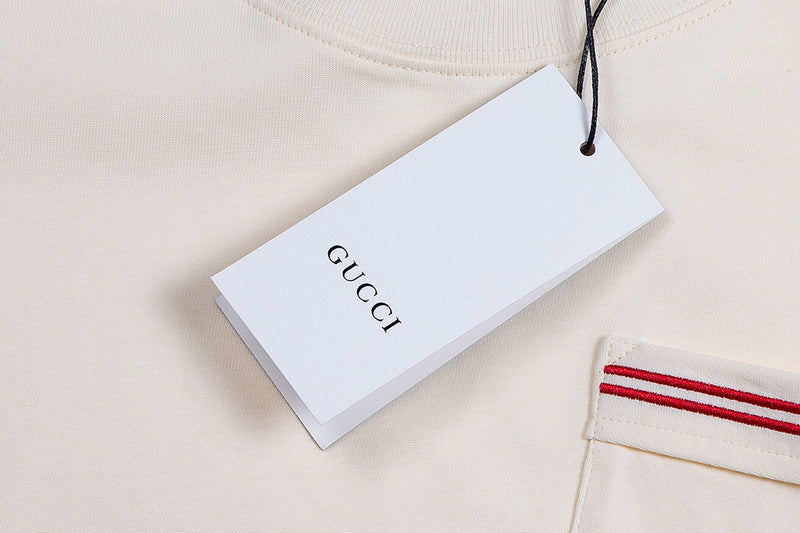 Flat lay presentation of Gucci luxury clothing with signature branding