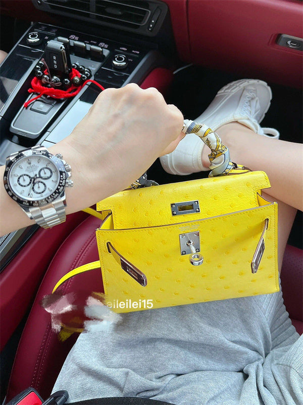  Understated top-handle bag carried on shoulder