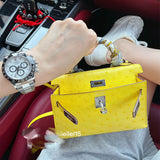  Understated top-handle bag carried on shoulder