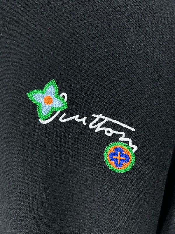 Flat lay presentation of Louis Vuitton luxury clothing with logo-detail design
