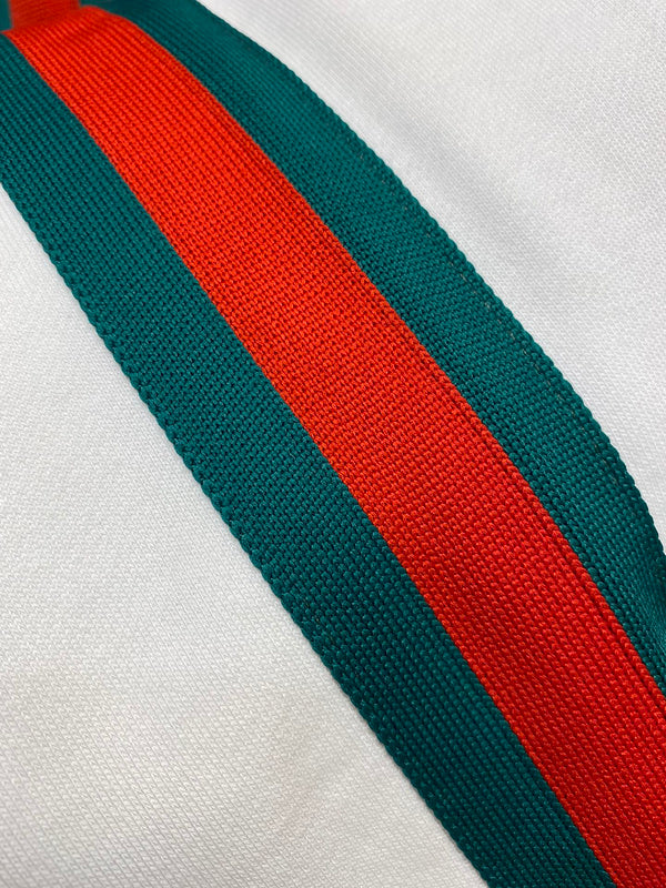 Flat lay presentation of Gucci luxury clothing with runway-inspired design