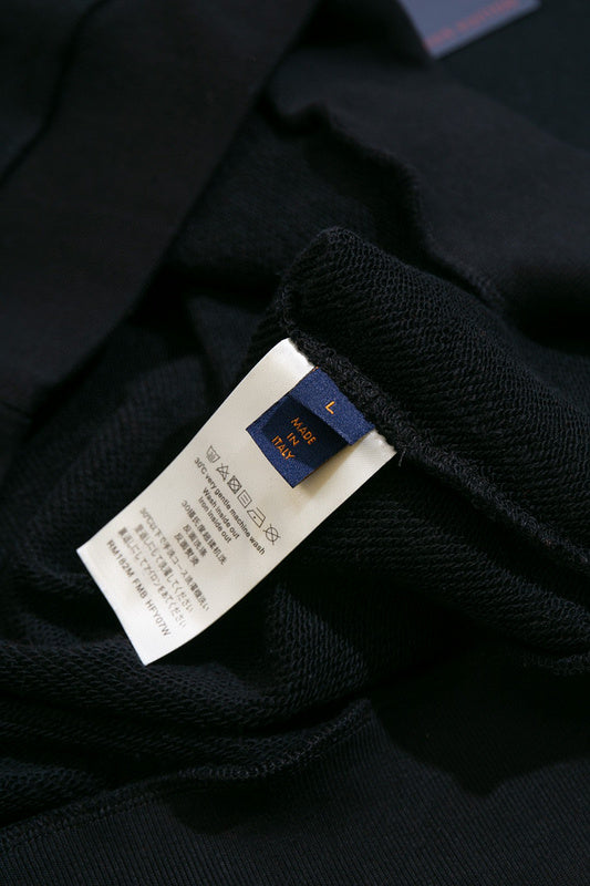 Close-up detail shot of Louis Vuitton luxury clothing with label-forward styling