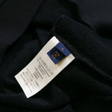 Close-up detail shot of Louis Vuitton luxury clothing with label-forward styling