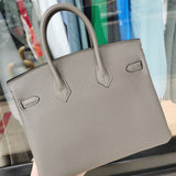  Signature shoulder bag carried on shoulder