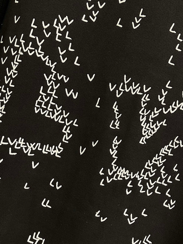 Flat lay presentation of Louis Vuitton luxury clothing with tailored silhouette