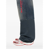Close-up of Balenciaga pants hardware and fine stitching