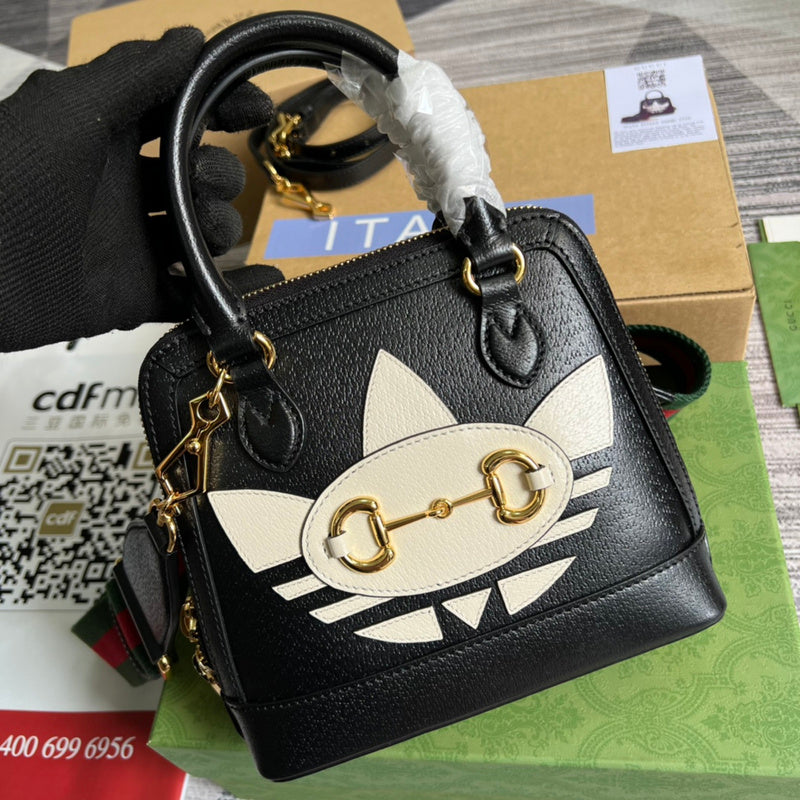 Handle and strap detail of polished statement women's handbag – women's luxury accessory