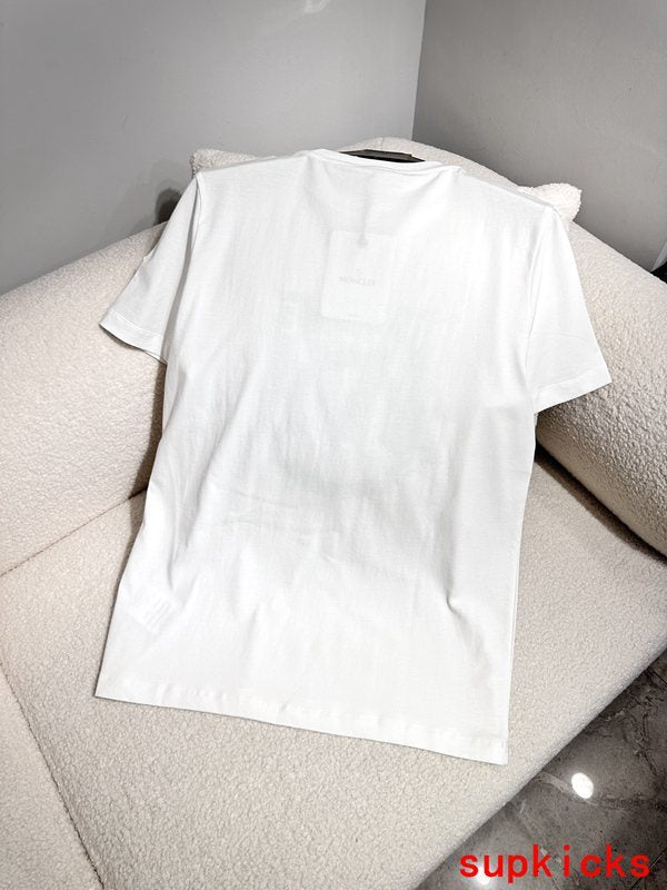 Flat lay presentation of Moncler luxury clothing with monogram-inspired silhouette