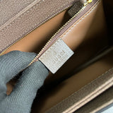 Side profile of polished classic women's handbag – women's statement bag