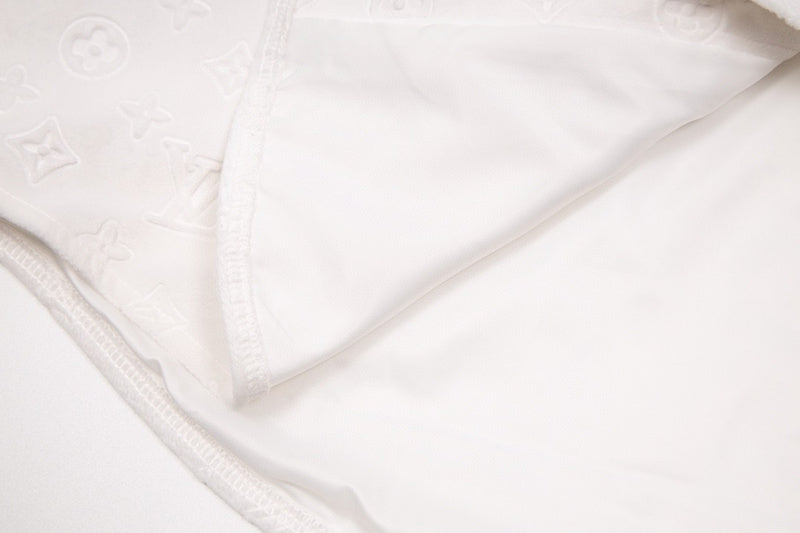 Flat lay presentation of Louis Vuitton luxury clothing with logo-detail design