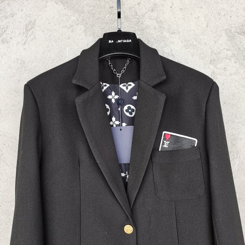 Close-up detail shot of Louis Vuitton luxury clothing with logo-detail design