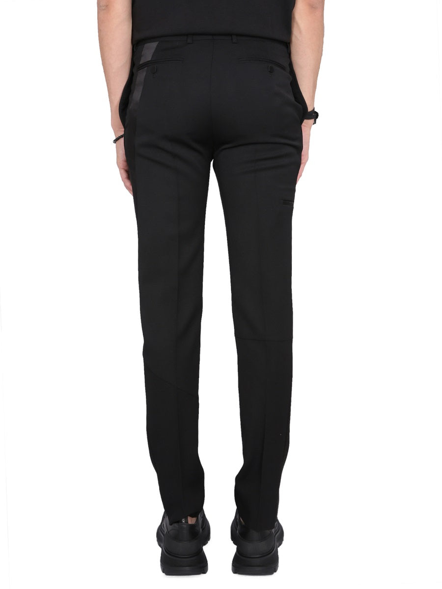 Close-up of Alexander McQueen pants hardware and fine stitching