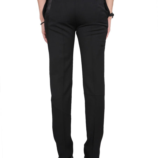 Close-up of Alexander McQueen pants hardware and fine stitching