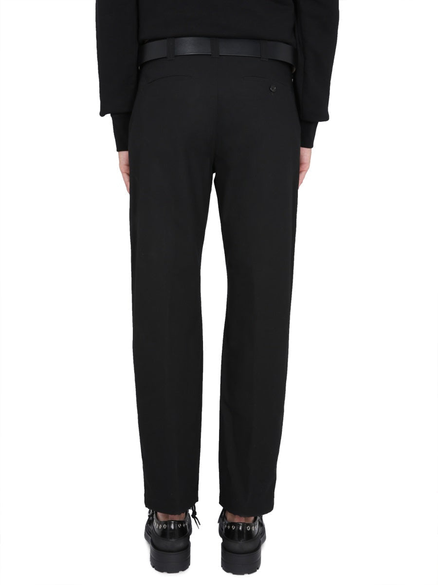 Close-up of Alexander McQueen pants hardware and fine stitching