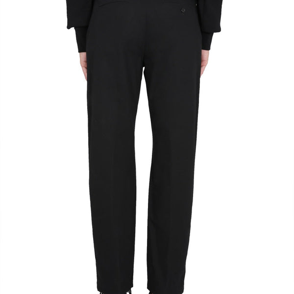 Close-up of Alexander McQueen pants hardware and fine stitching