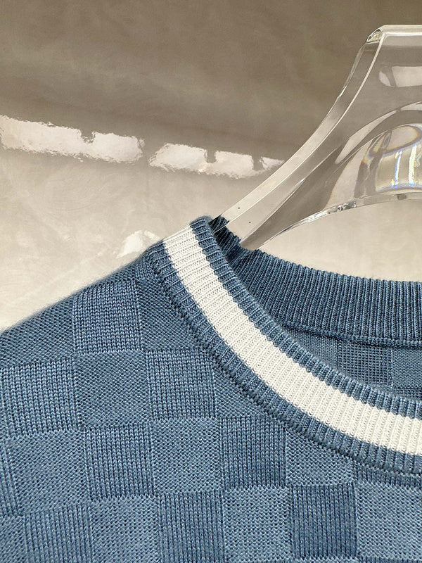 Close-up detail shot of Louis Vuitton luxury clothing with signature branding