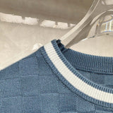 Close-up detail shot of Louis Vuitton luxury clothing with signature branding