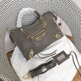 Front view of sleek polished women's handbag – women's luxury accessory