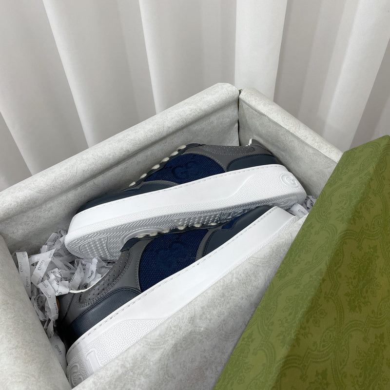 Side profile of Gucci crisp white sneakers retro runner design
