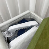 Side profile of Gucci crisp white sneakers retro runner design