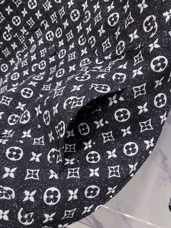 Flat lay presentation of Louis Vuitton luxury clothing with label-forward styling