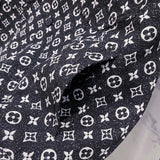 Flat lay presentation of Louis Vuitton luxury clothing with label-forward styling