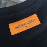 Close-up detail shot of Louis Vuitton cotton t-shirt with label-forward styling