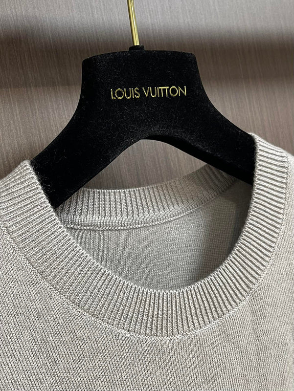 Close-up detail shot of Louis Vuitton luxury clothing with signature branding