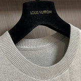 Close-up detail shot of Louis Vuitton luxury clothing with signature branding