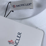 Flat lay presentation of Moncler luxury clothing with signature branding