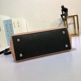 Styled lifestyle shot of structured signature women's handbag – women's statement bag