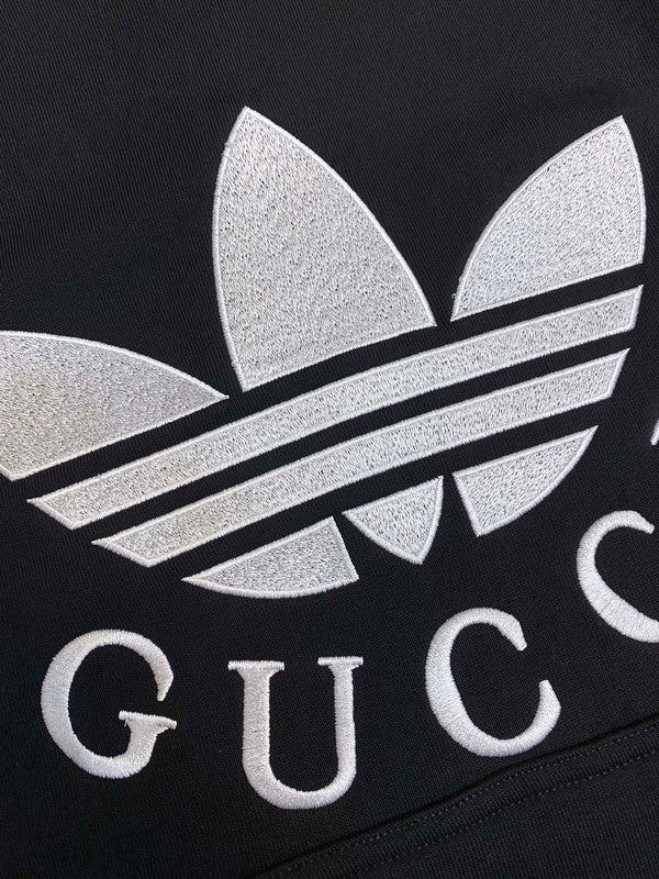 Flat lay presentation of Gucci luxury clothing with label-forward styling