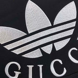 Flat lay presentation of Gucci luxury clothing with label-forward styling
