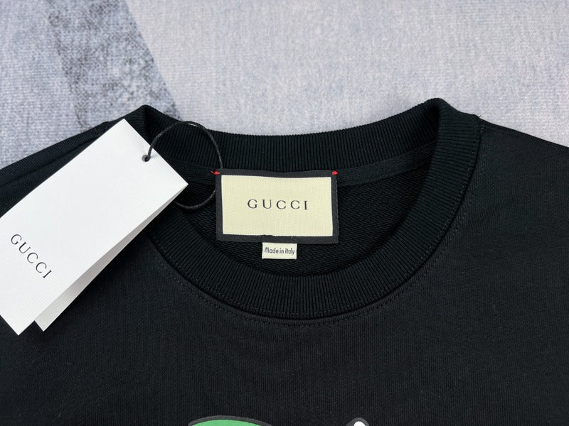 Close-up detail shot of Gucci luxury clothing with signature branding