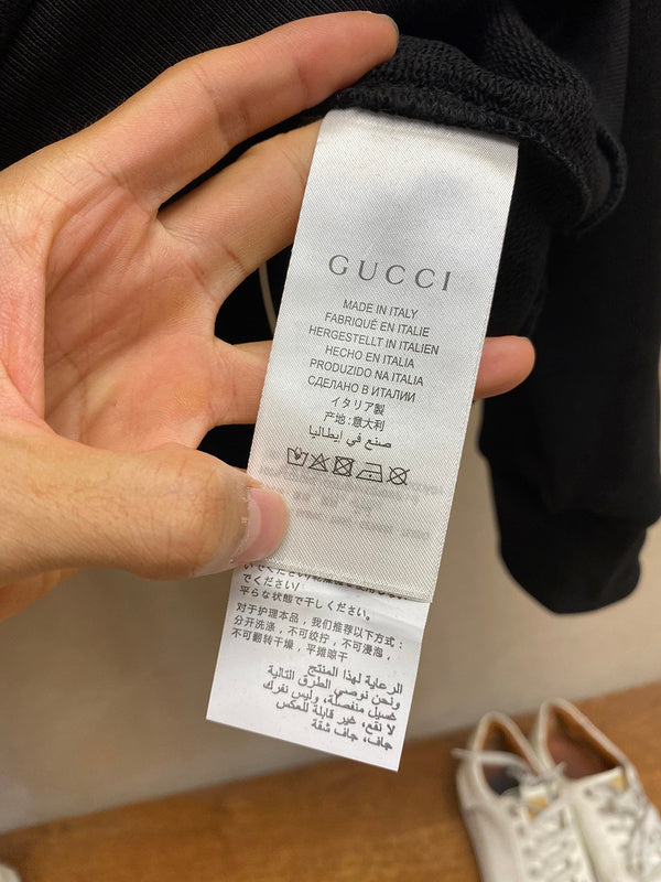 Back view of Gucci luxury clothing with label-forward styling