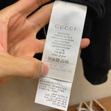 Back view of Gucci luxury clothing with label-forward styling