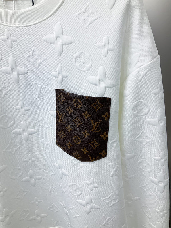 Flat lay presentation of Louis Vuitton luxury clothing with label-forward styling
