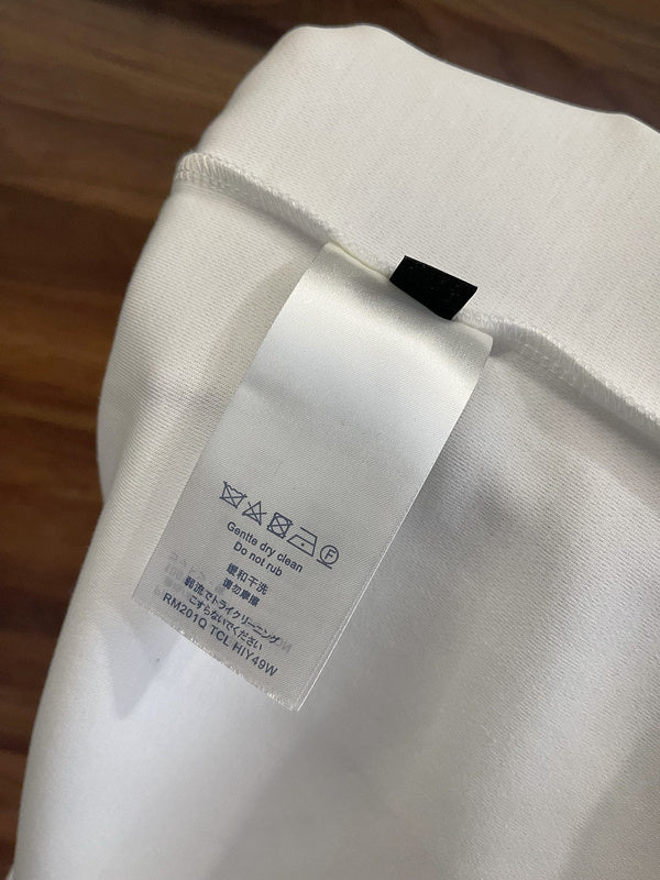 Close-up detail shot of Louis Vuitton luxury clothing with label-forward styling