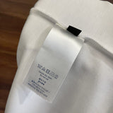 Close-up detail shot of Louis Vuitton luxury clothing with label-forward styling