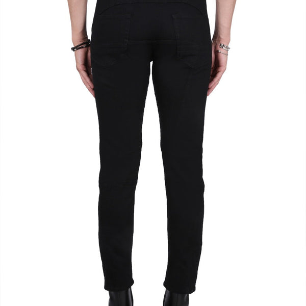 Close-up of Alexander McQueen pants hardware and fine stitching