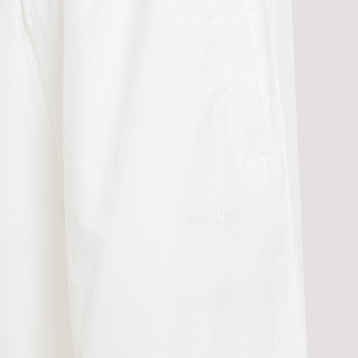 Close-up of Balenciaga pants hardware and fine stitching