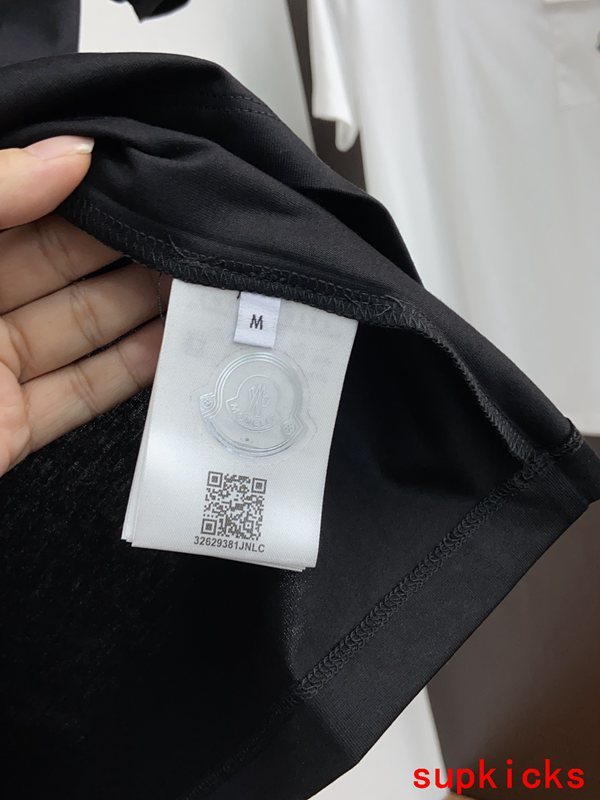 Flat lay presentation of Moncler luxury clothing with contemporary cut