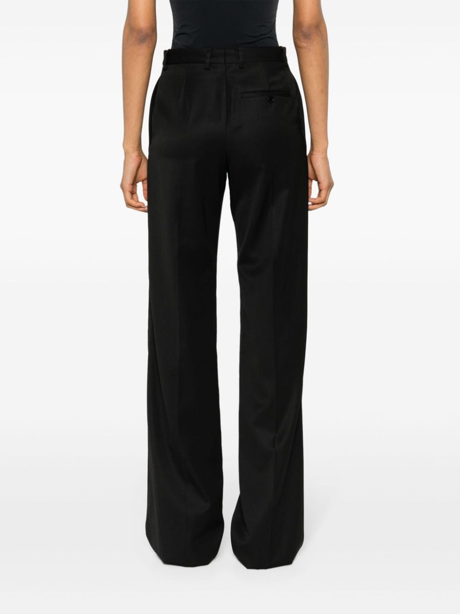 Close-up of Balenciaga pants hardware and fine stitching