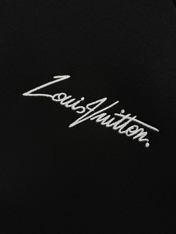 Flat lay presentation of Louis Vuitton luxury clothing with label-forward styling