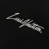 Flat lay presentation of Louis Vuitton luxury clothing with label-forward styling