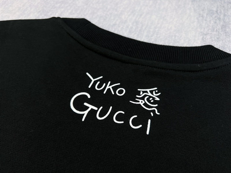 Front view of Gucci luxury clothing with signature branding